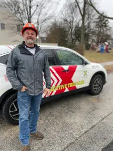 Doug Bull, ISA Certified Arborist, standing with Executive Tree Care vehicle in Havertown PA